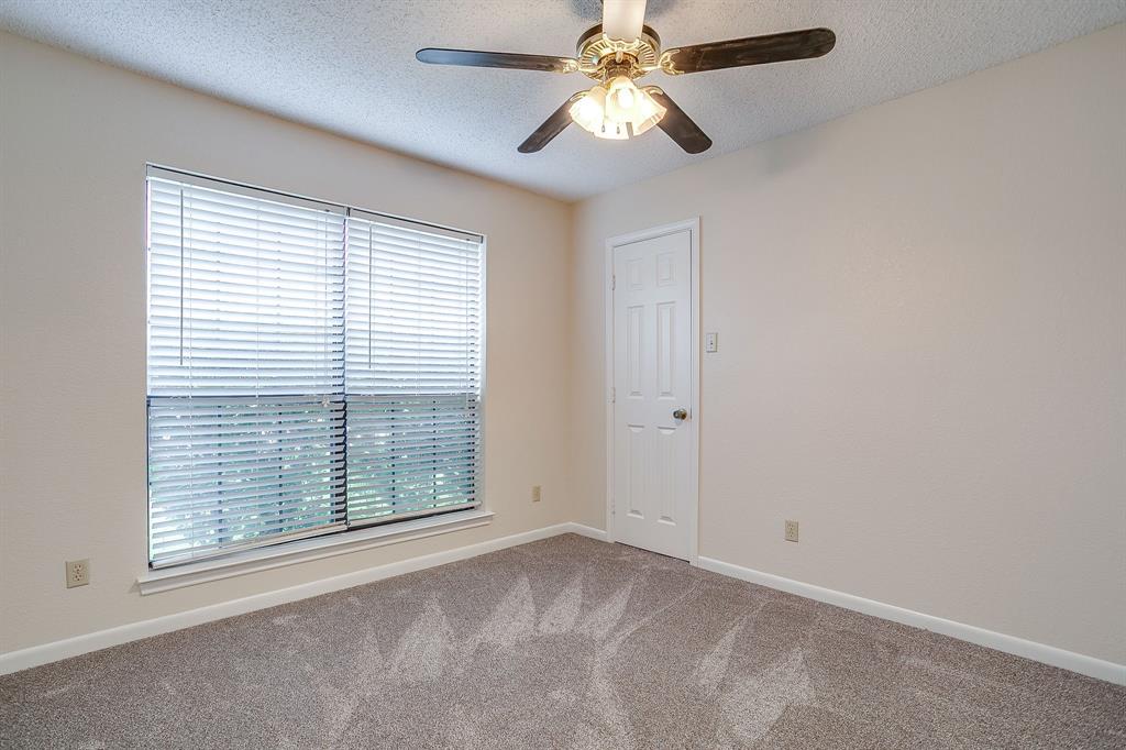 8613 Silver Creek Road White Settlement, TX 76108 - Photo 26 of 40 an empty room with windows and fan