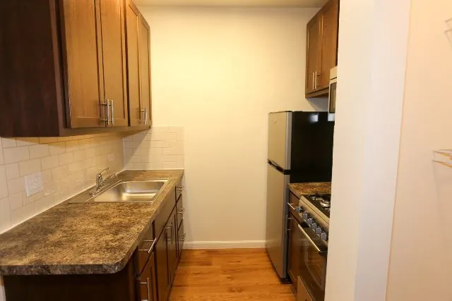 a kitchen with a refrigerator and a stove