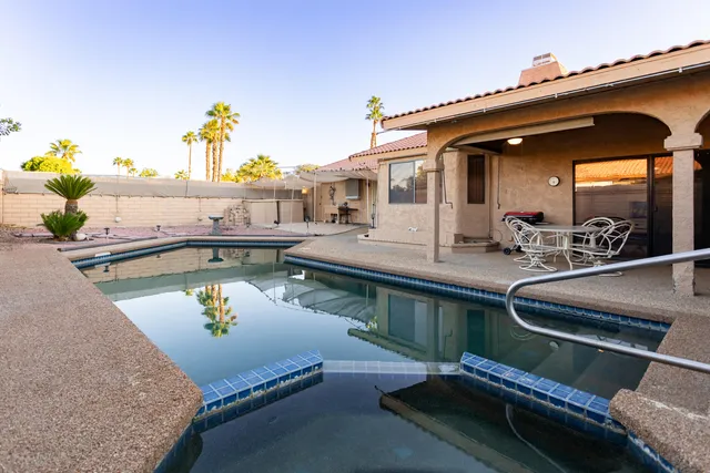 a view of a balcony with chairs and wooden floor