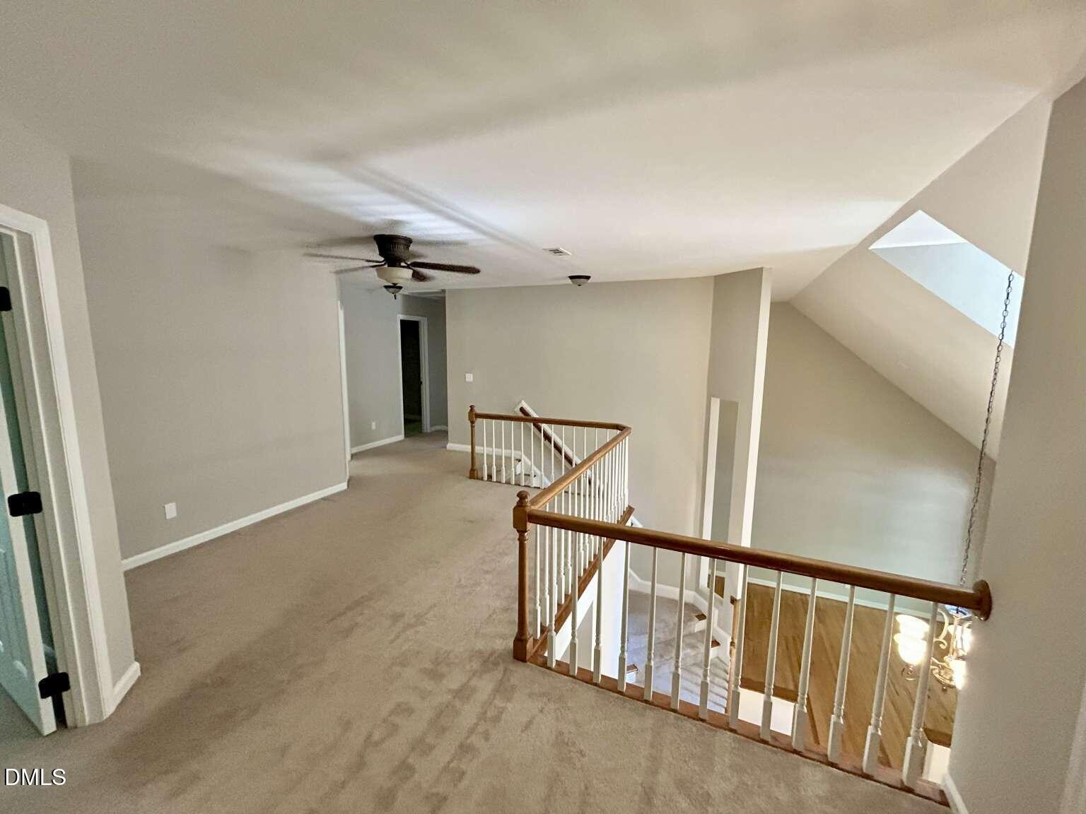 113 Ravenna Way Cary, NC 27513 - Photo 14 of 39 a view of staircase with lots of frames on wall