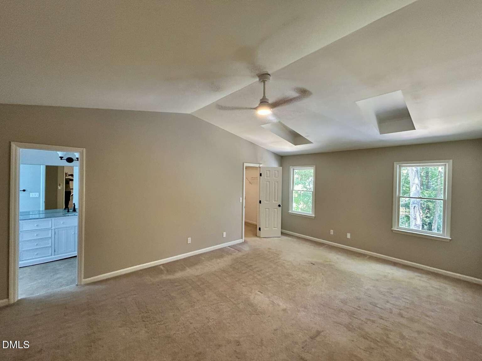 113 Ravenna Way Cary, NC 27513 - Photo 15 of 39 an empty room with chandelier fan and windows