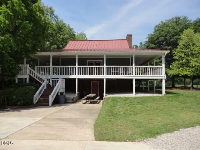 a view of a backyard with swimming pool