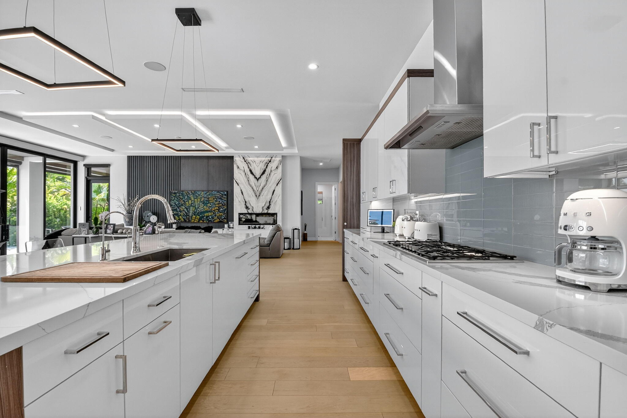 770 Enfield Street Boca Raton, FL 33487 - Photo 25 of 90 a large kitchen with stainless steel appliances kitchen island granite countertop a lot of counter space and a sink