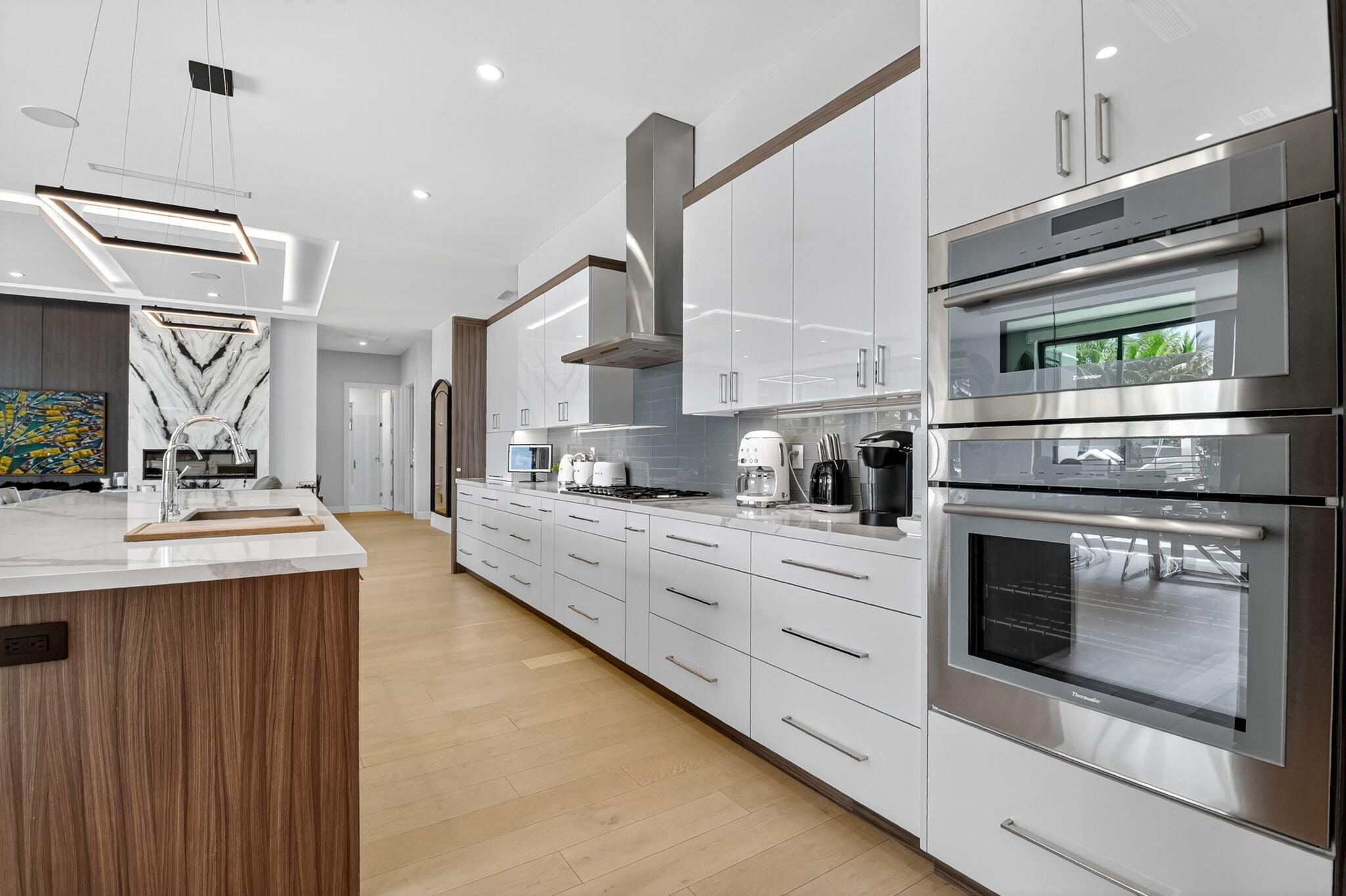 770 Enfield Street Boca Raton, FL 33487 - Photo 26 of 90 a kitchen with stainless steel appliances kitchen island granite countertop a stove a sink and a microwave