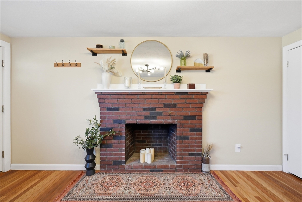 27 Garfield Avenue Saugus, MA 01906 - Photo 13 of 41 a living room with a fireplace and wooden floor