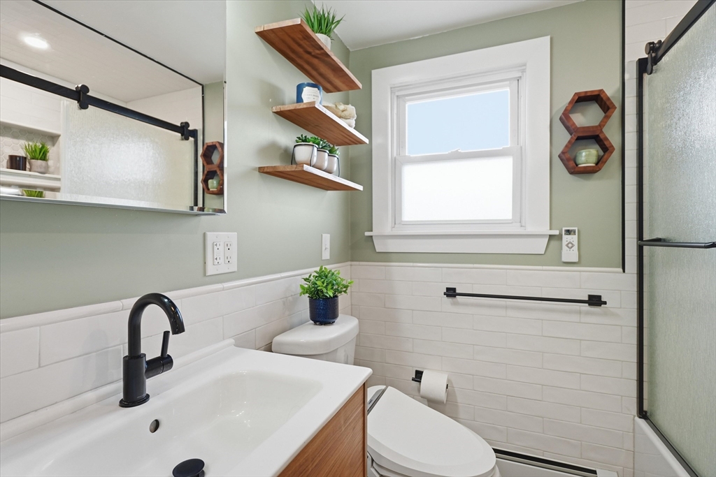 27 Garfield Avenue Saugus, MA 01906 - Photo 15 of 41 a bathroom with a sink a toilet and a mirror