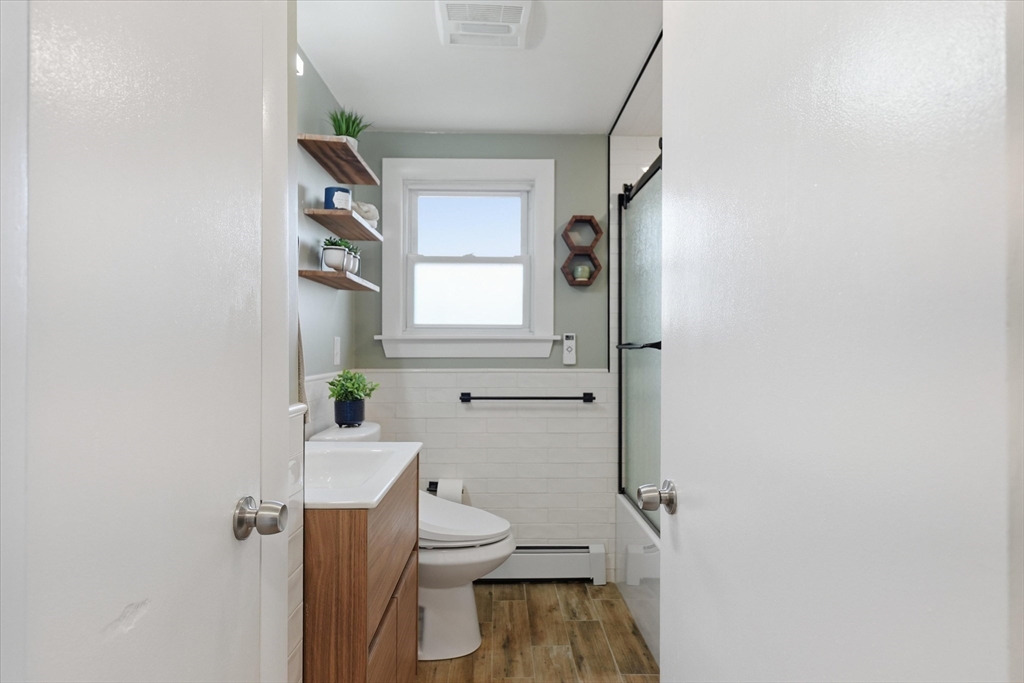 27 Garfield Avenue Saugus, MA 01906 - Photo 17 of 41 a bathroom with a toilet a sink and a window