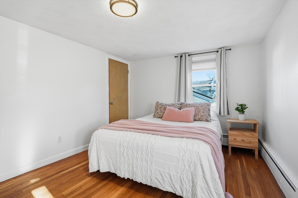 27 Garfield Avenue Saugus, MA 01906 - Photo 30 of 41 a bedroom with a bed and wooden floor