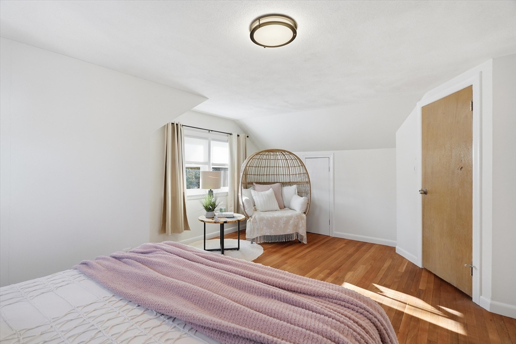 27 Garfield Avenue Saugus, MA 01906 - Photo 31 of 41 a bedroom with a bed and chandelier