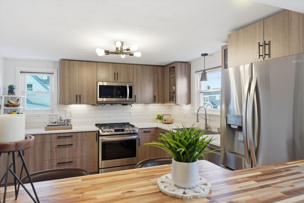 27 Garfield Avenue Saugus, MA 01906 - Photo 6 of 41 a kitchen with a refrigerator a stove and cabinets