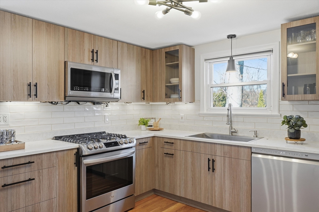 27 Garfield Avenue Saugus, MA 01906 - Photo 8 of 41 a kitchen with cabinets stainless steel appliances a sink and a window