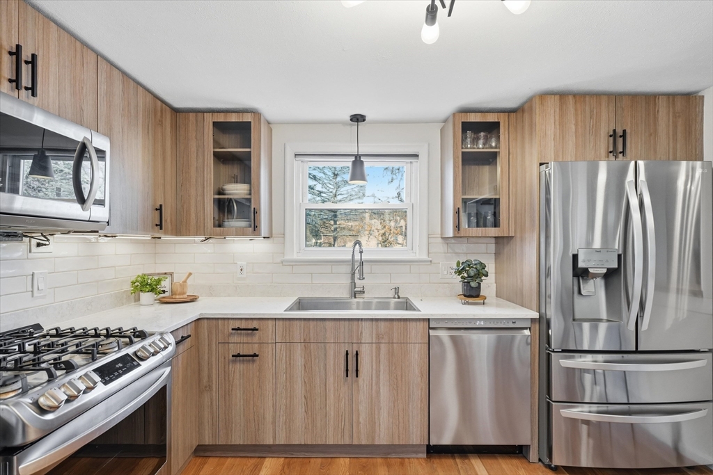 27 Garfield Avenue Saugus, MA 01906 - Photo 9 of 41 a kitchen with kitchen island a sink stove and refrigerator