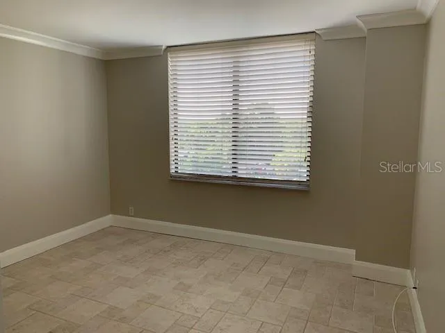 an empty room with closet and a bathroom