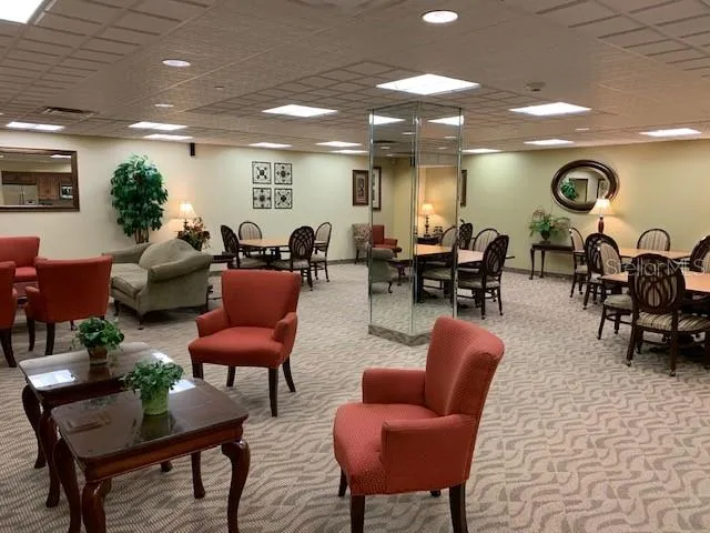 a living room with furniture a rug and a fireplace