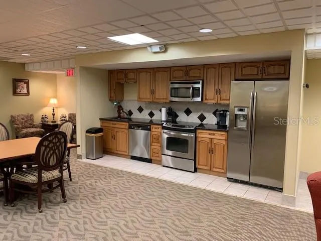 a living room with furniture a flat screen tv and a lamp