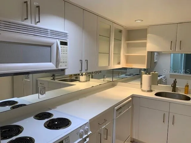 a kitchen with a sink stove and cabinets