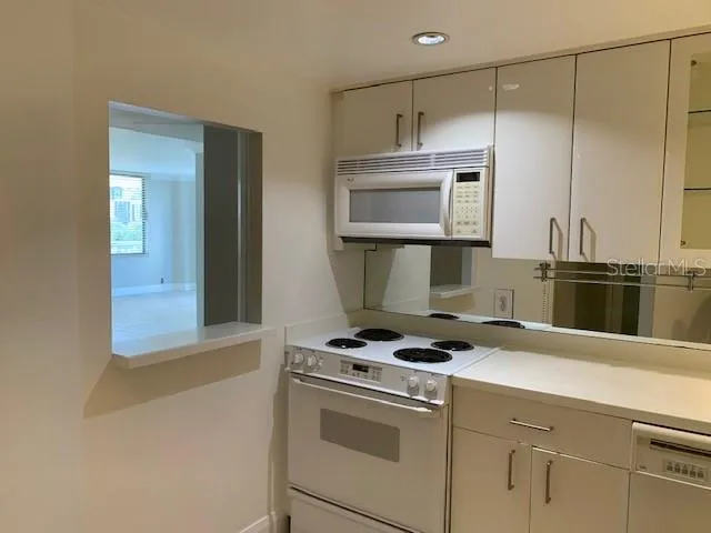 a kitchen with a stove and a microwave