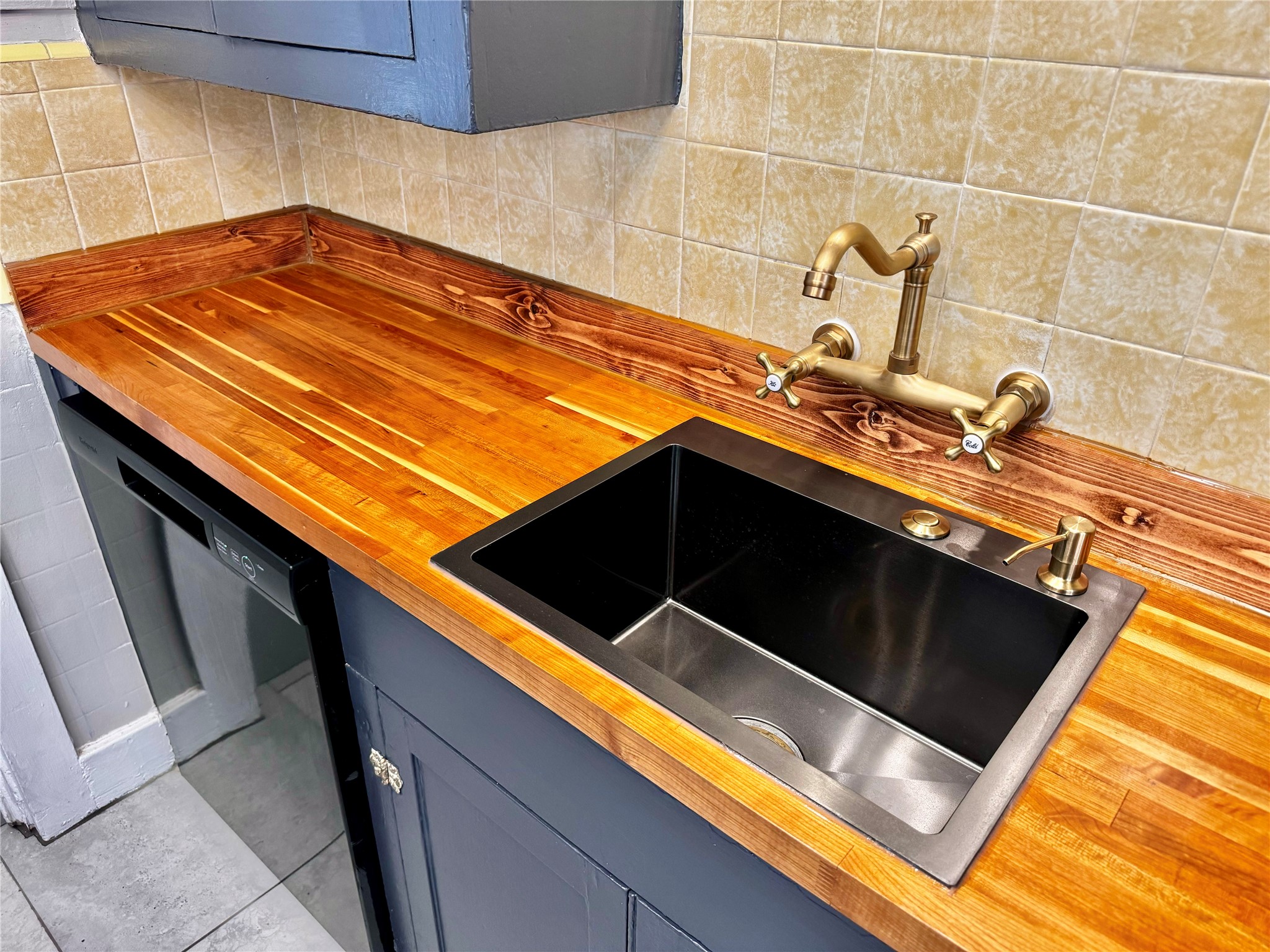 1018 Dunbar Street Houston, TX 77009 - Photo 17 of 30 Zoom in on some of the stylish choices in this home! Wood butcher-block, a black metal sink, and brushed gold fixtures with vintage charm! Yellow tile original to this 1930s home!