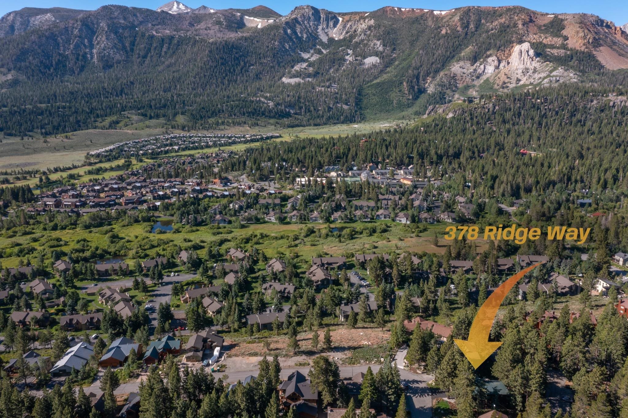 378 Ridge Way Mammoth Lakes, CA 93546 - Photo 43 of 43 Aerial perspective showcasing a community nestled among dense evergreen forests, with a prominent mountainous backdrop