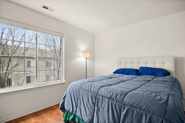 a bed sitting in a bedroom next to a window