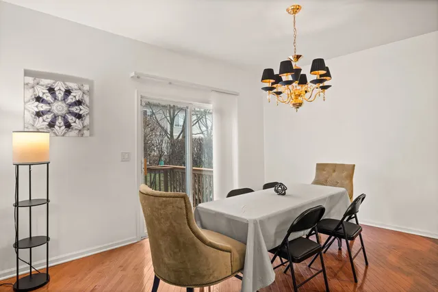 a view of a dining room with a table and chairs