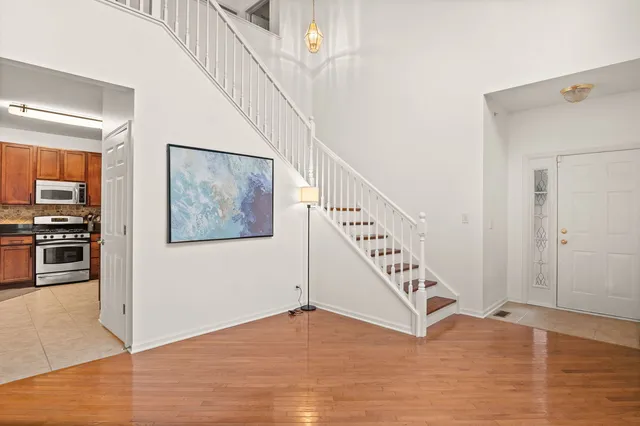 a view of an entryway with wooden floor
