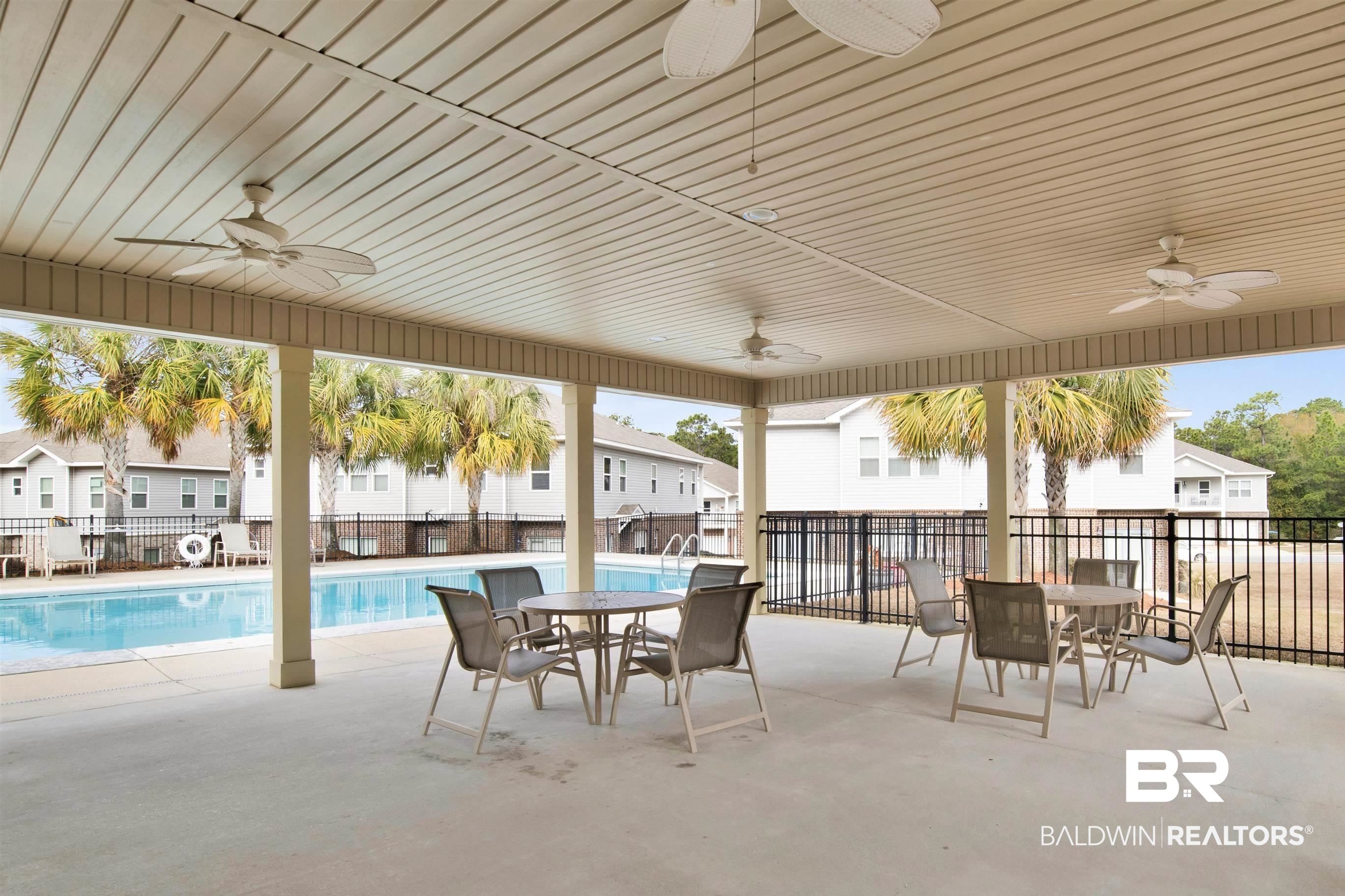 6811 Spaniel Drive, Unit C Daphne, AL 36527 - Photo 26 of 33 View of patio with ceiling fan, outdoor dining area, and a community pool