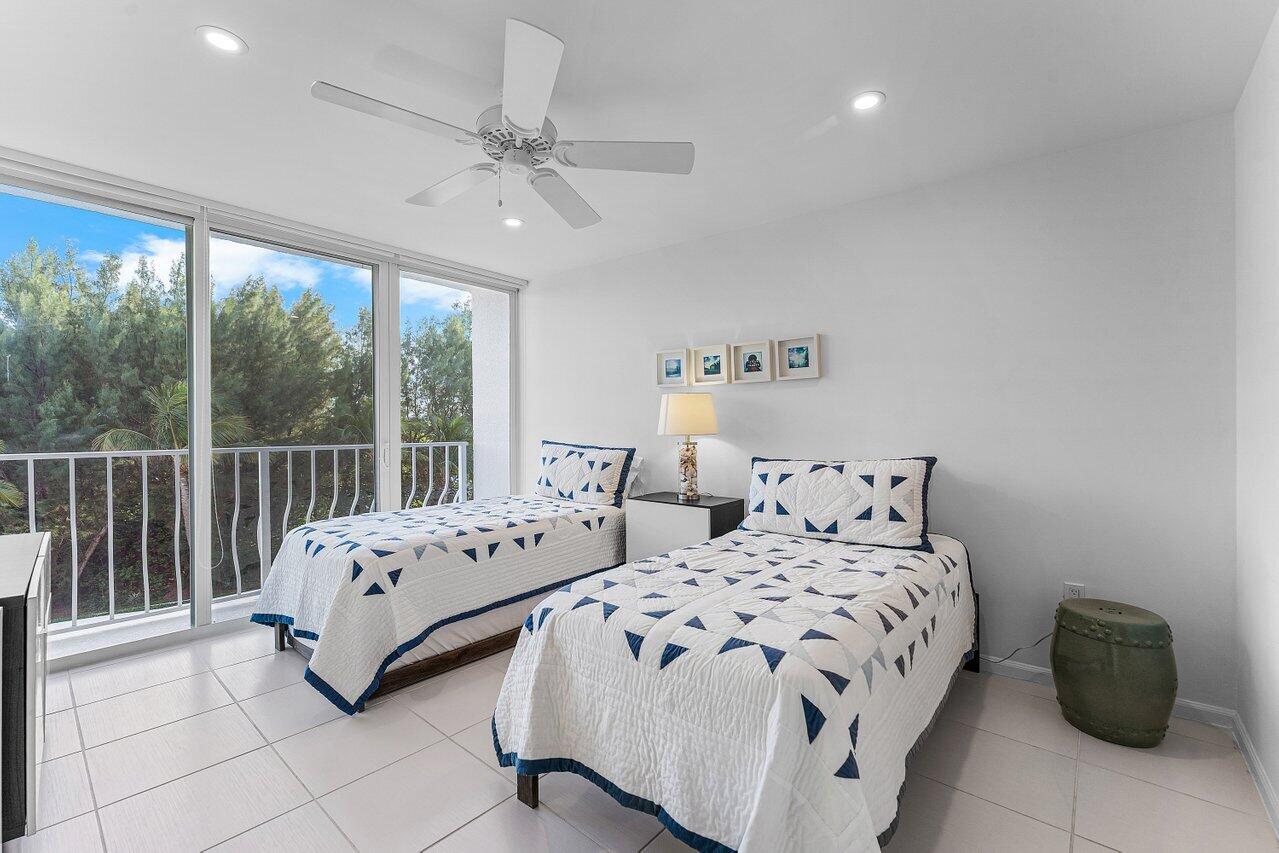 2774 South Ocean Boulevard, Unit 409 Palm Beach, FL 33480 - Photo 12 of 32 a bedroom with two beds and large window