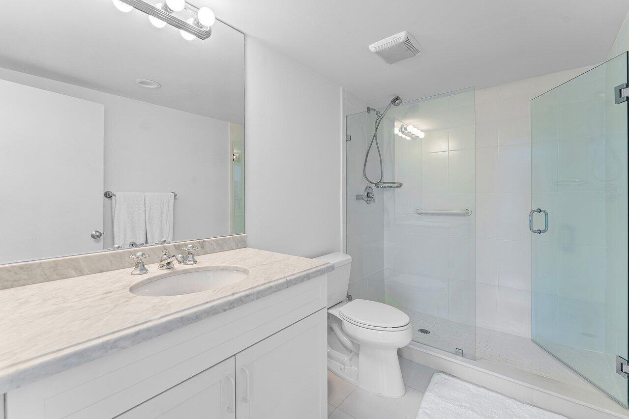 2774 South Ocean Boulevard, Unit 409 Palm Beach, FL 33480 - Photo 14 of 32 a bathroom with a sink a toilet and shower