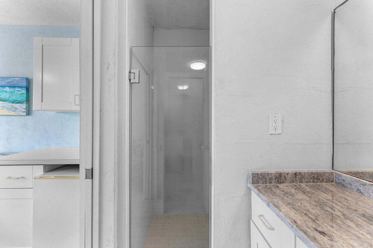 2774 South Ocean Boulevard, Unit 409 Palm Beach, FL 33480 - Photo 18 of 32 a bathroom with a granite countertop sink and a mirror