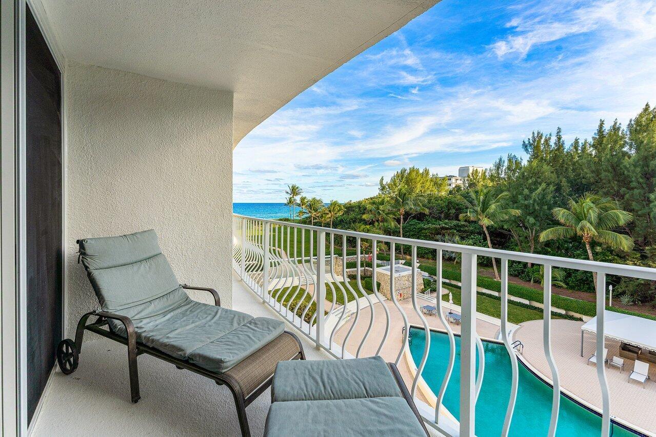 2774 South Ocean Boulevard, Unit 409 Palm Beach, FL 33480 - Photo 2 of 32 a view of a balcony with chair and wooden floor