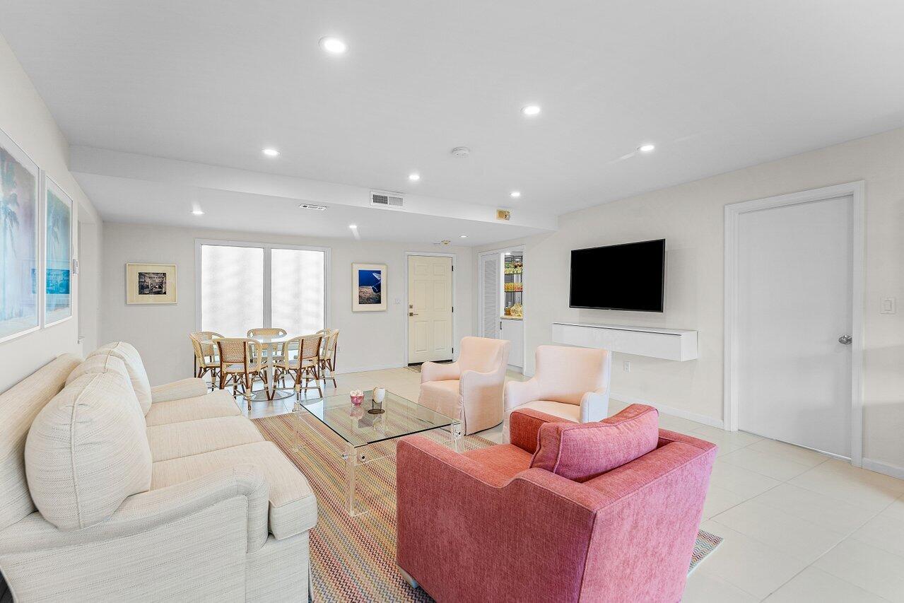 2774 South Ocean Boulevard, Unit 409 Palm Beach, FL 33480 - Photo 5 of 32 a living room with furniture and a flat screen tv