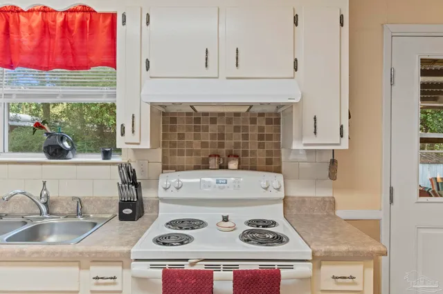 a kitchen with a stove and cabinets