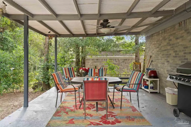 a dining room with furniture and a floor to ceiling window