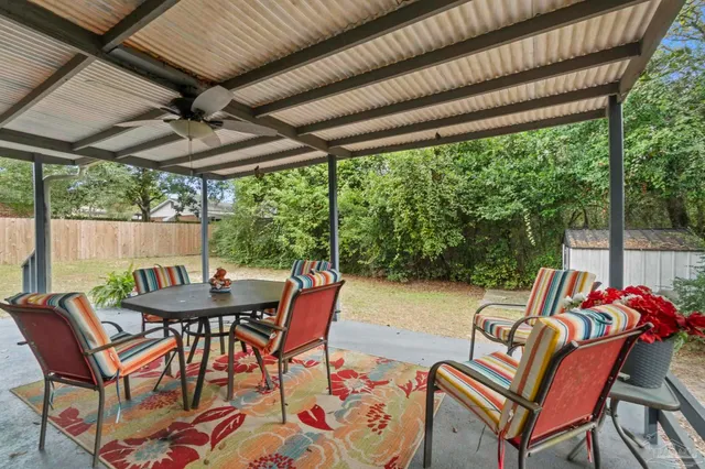 a view of a patio with a backyard table and chairs