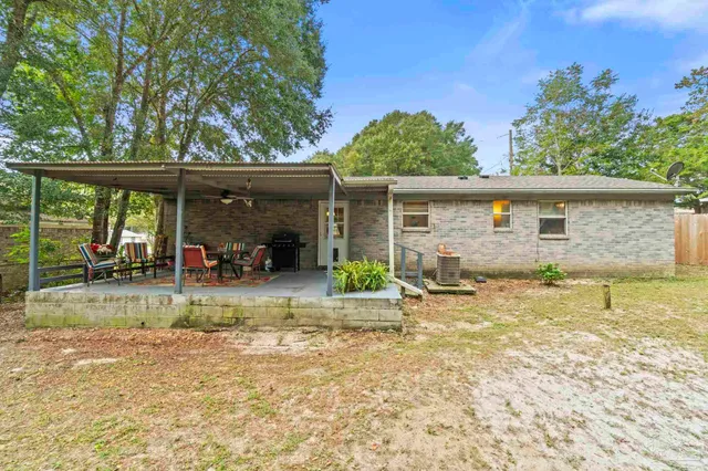 a view of a house with backyard and porch