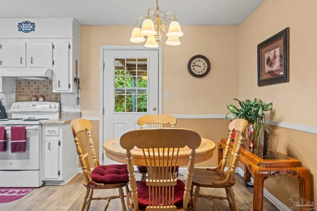 a view of a dining room with furniture and a chandelier