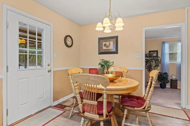 a view of a dining room with furniture and chandelier