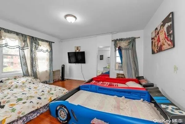 a bedroom with a bed and a flat screen tv