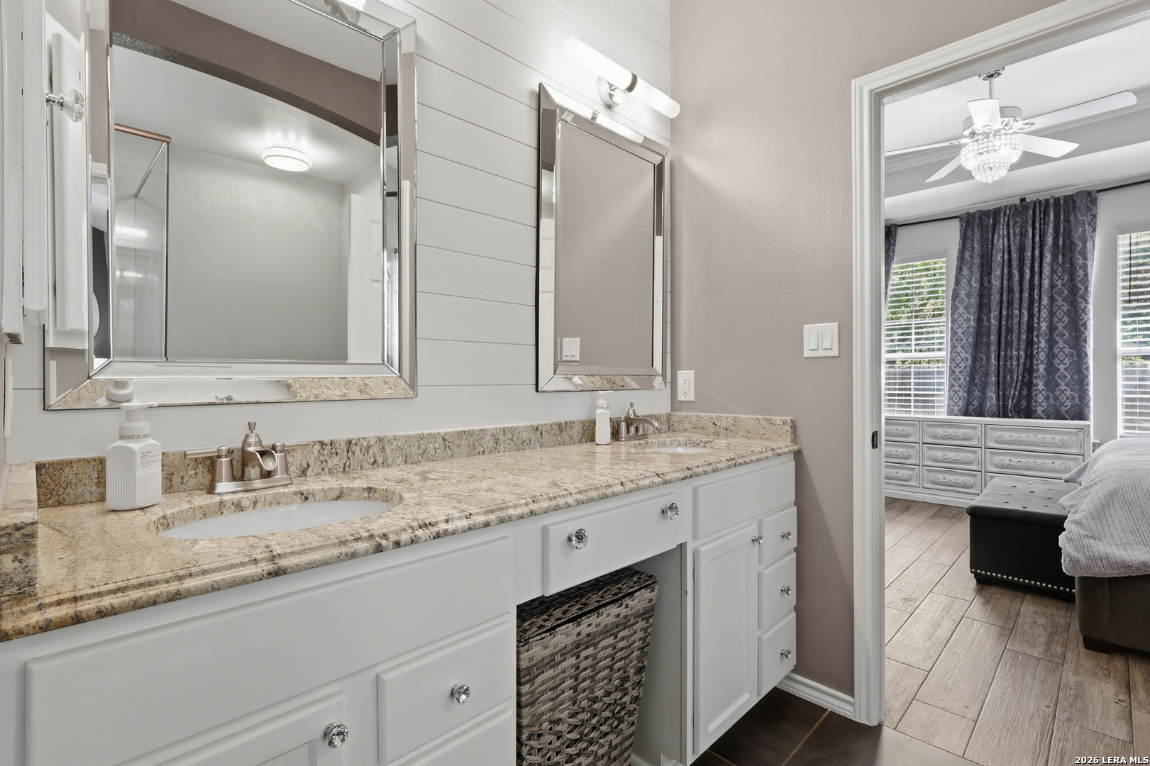 12703 Holly Cedar Helotes, TX 78023 - Photo 11 of 23 a bathroom with a granite countertop sink double vanity and a mirror