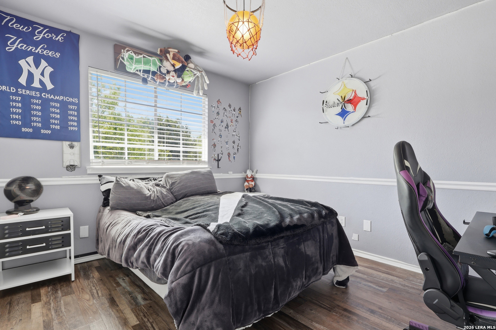 12703 Holly Cedar Helotes, TX 78023 - Photo 17 of 23 a bedroom with a bed and a chandelier