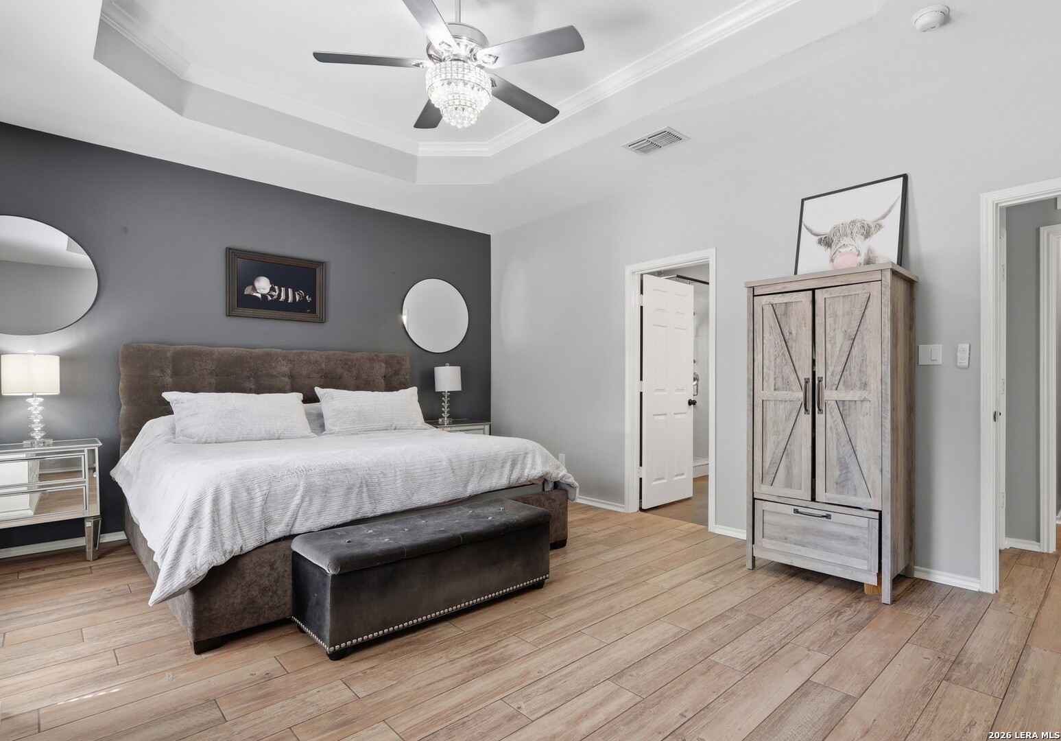 12703 Holly Cedar Helotes, TX 78023 - Photo 8 of 23 a bedroom with a bed and a chandelier