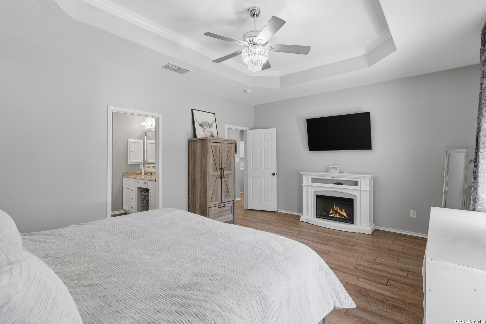 12703 Holly Cedar Helotes, TX 78023 - Photo 9 of 23 a spacious bedroom with a bed and a flat screen tv