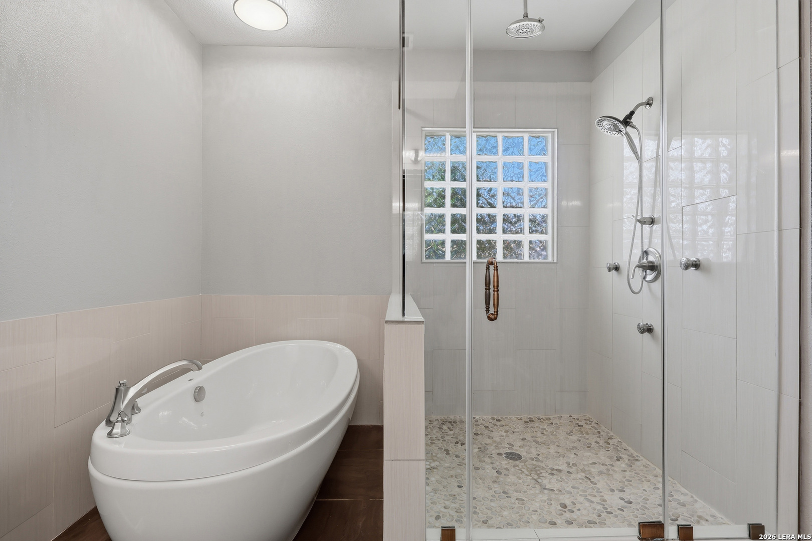 12703 Holly Cedar Helotes, TX 78023 - Photo 10 of 23 a bathroom with a bathtub and shower