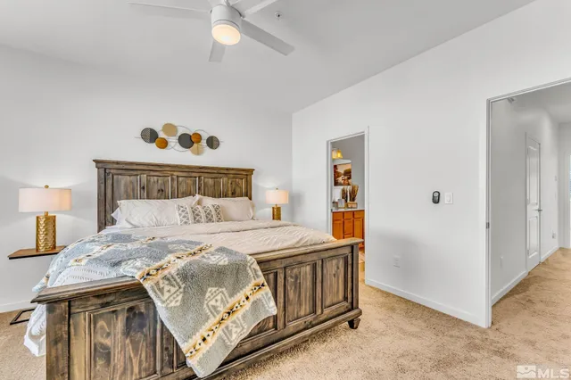 a bedroom with a bed and a painting on the wall