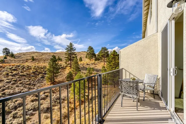 a view of a balcony with wooden floor and city view