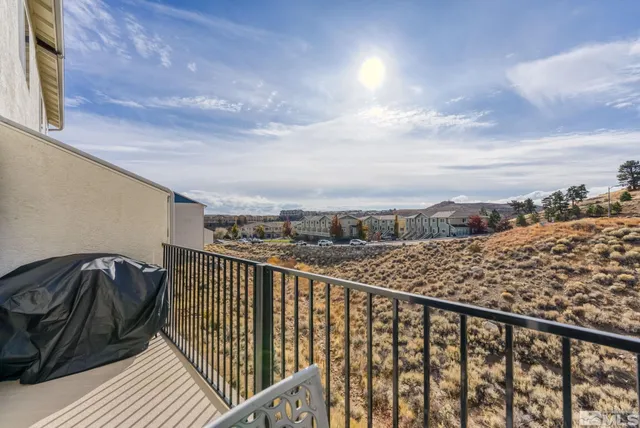 a view of a balcony with wooden floor and city view