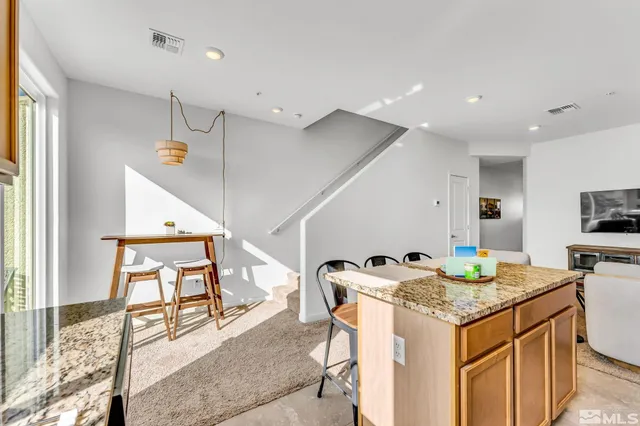 a kitchen that has a table and chairs in it