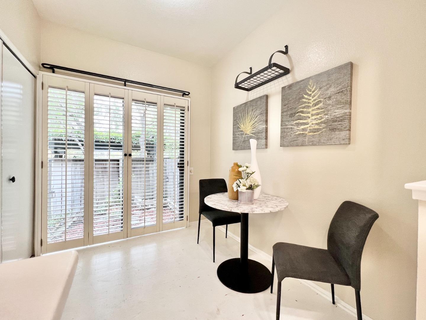 834 Wharfside Road San Mateo, CA 94404 - Photo 14 of 36 a view of a dining room with furniture and a large window