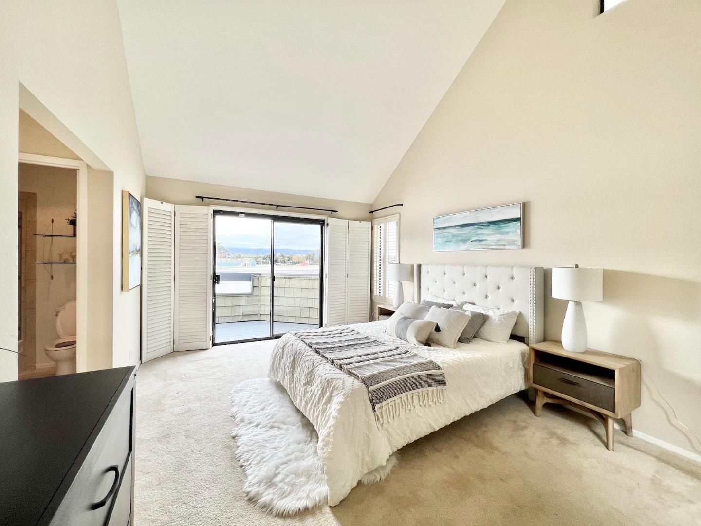 834 Wharfside Road San Mateo, CA 94404 - Photo 17 of 36 a bedroom with a bed and a night stand